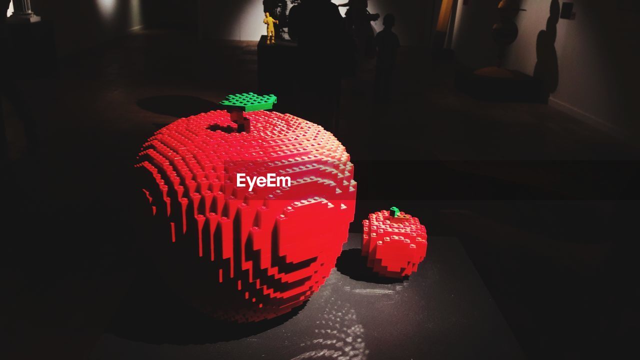 CLOSE-UP OF ILLUMINATED RED AND TABLE