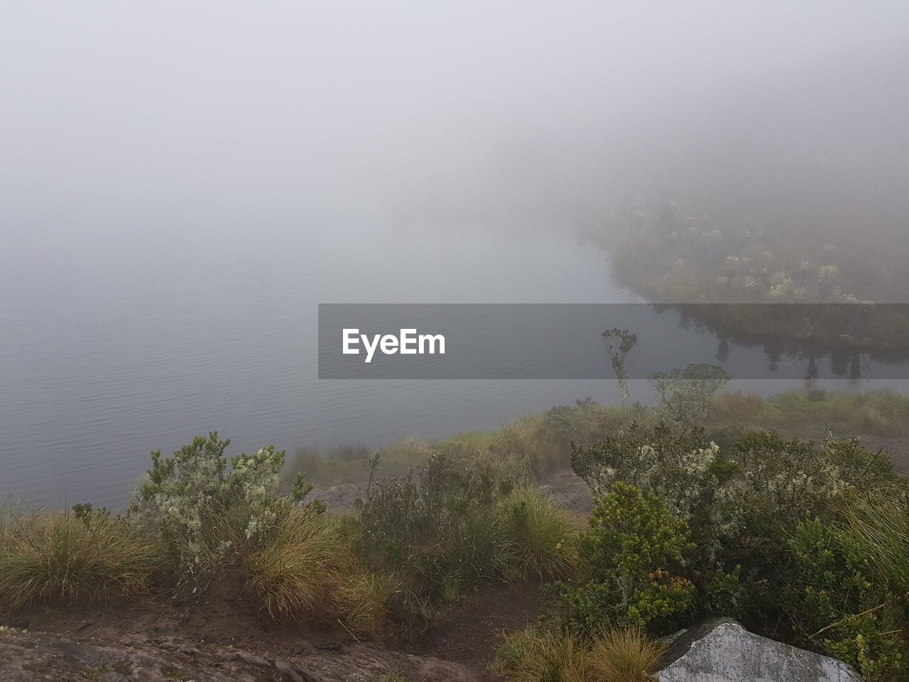 SCENIC VIEW OF LAKE AGAINST SKY IN FOGGY WEATHER