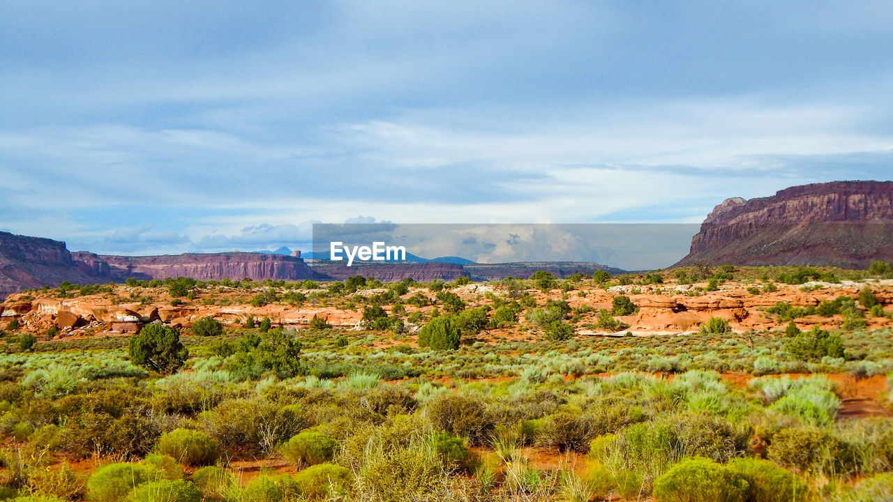 Scenic view of mountains against cloudy sky