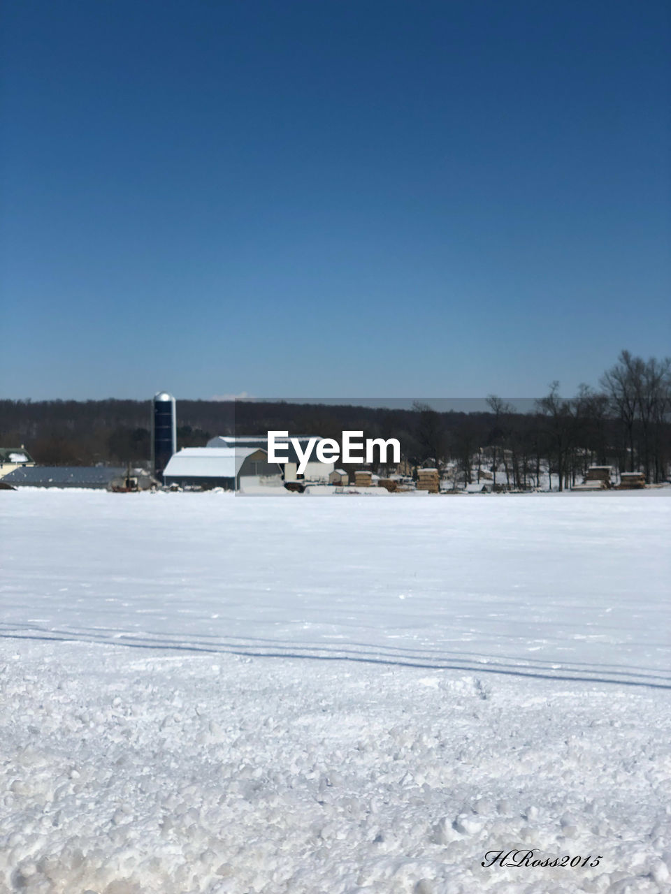 SNOW COVERED CAR AGAINST BLUE SKY