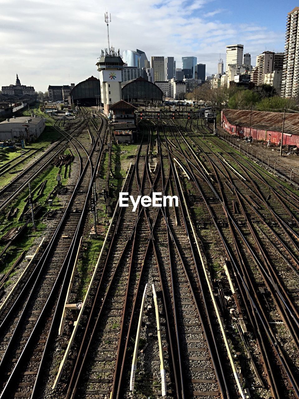 Railroad tracks in city against sky