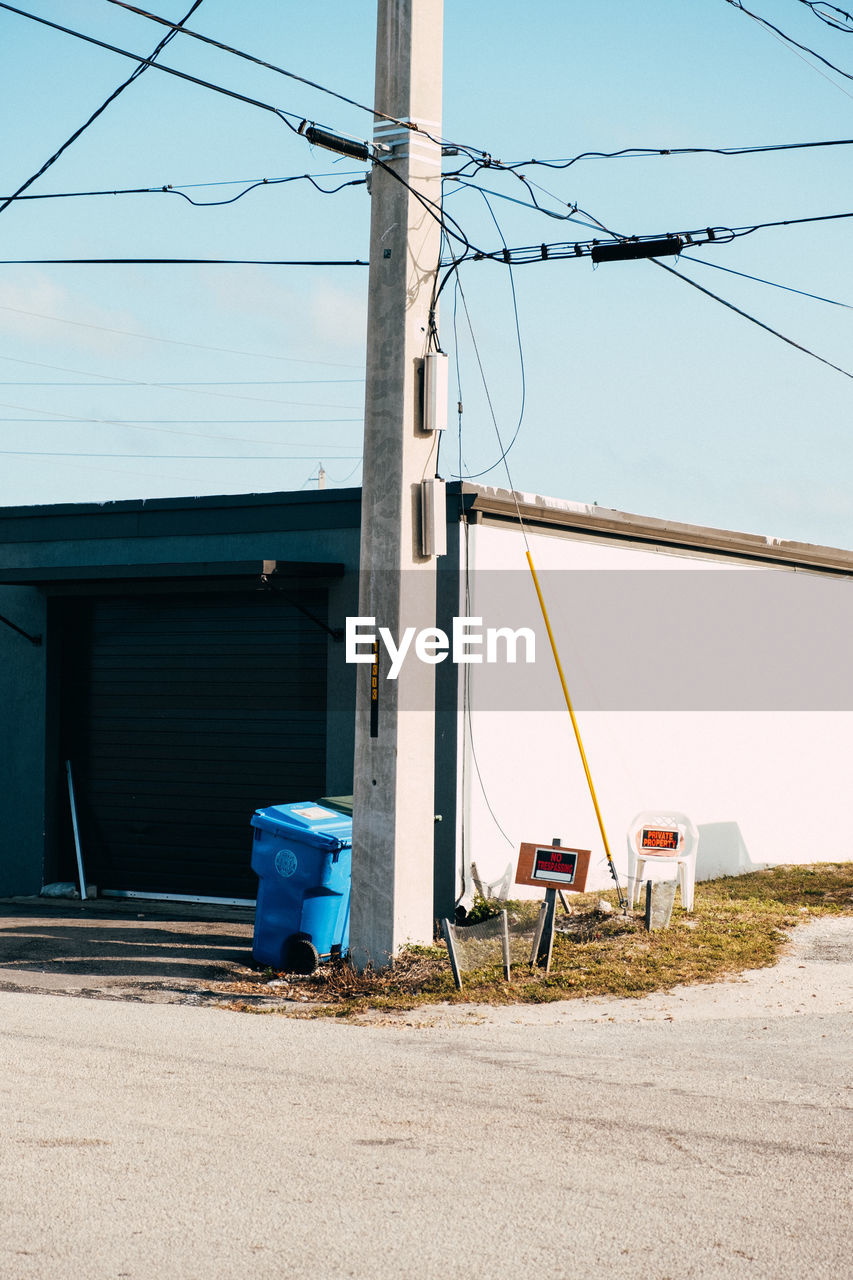 cable, electricity, power generation, architecture, power line, technology, nature, power supply, built structure, sky, day, no people, building exterior, electricity pylon, overhead power line, blue, outdoors, transportation, road, telephone pole, mast, building, clear sky, city