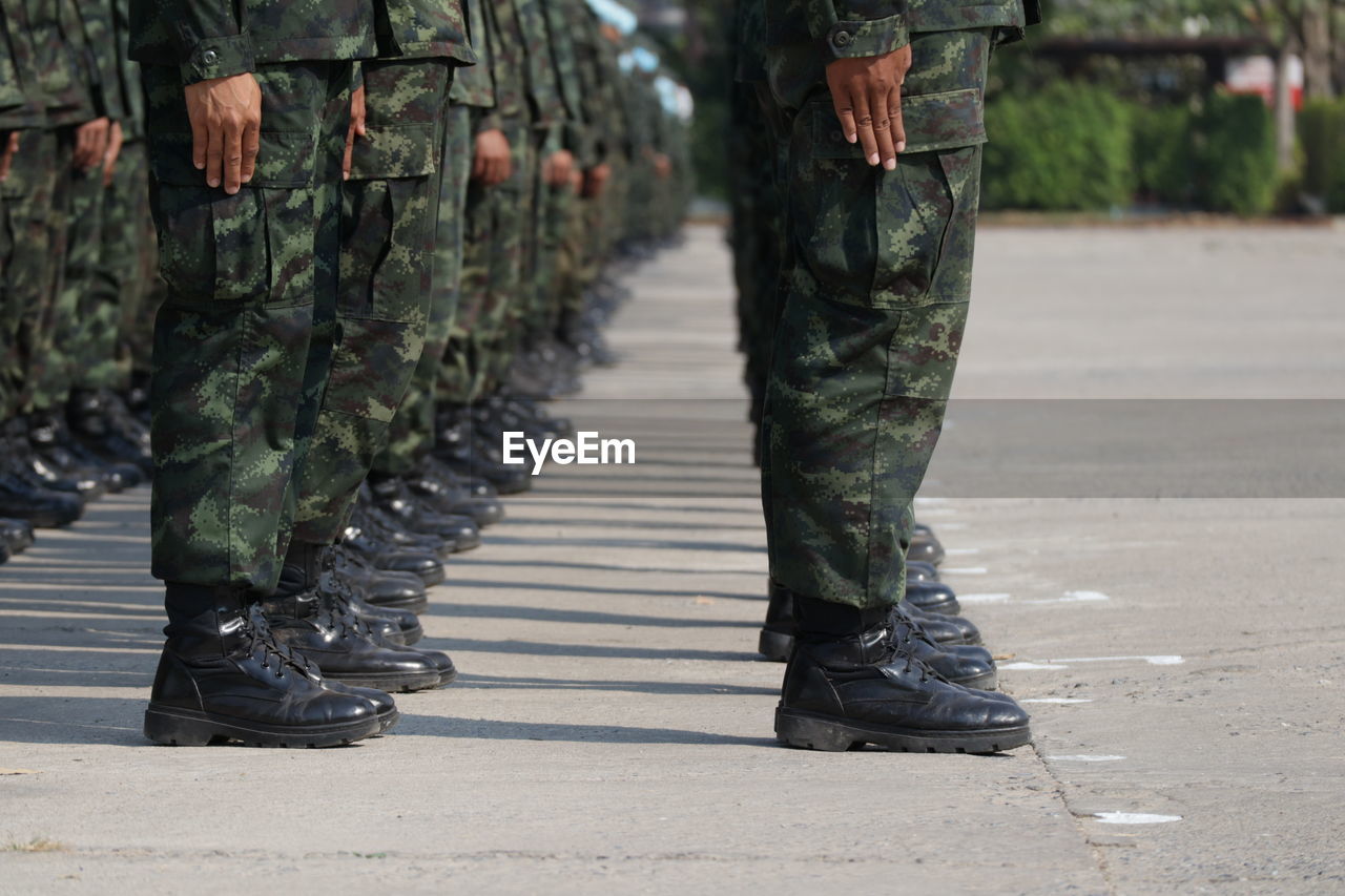 Low section of soldiers walking on street