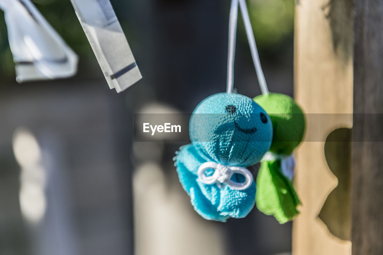 Close-up of toys hanging on clothesline