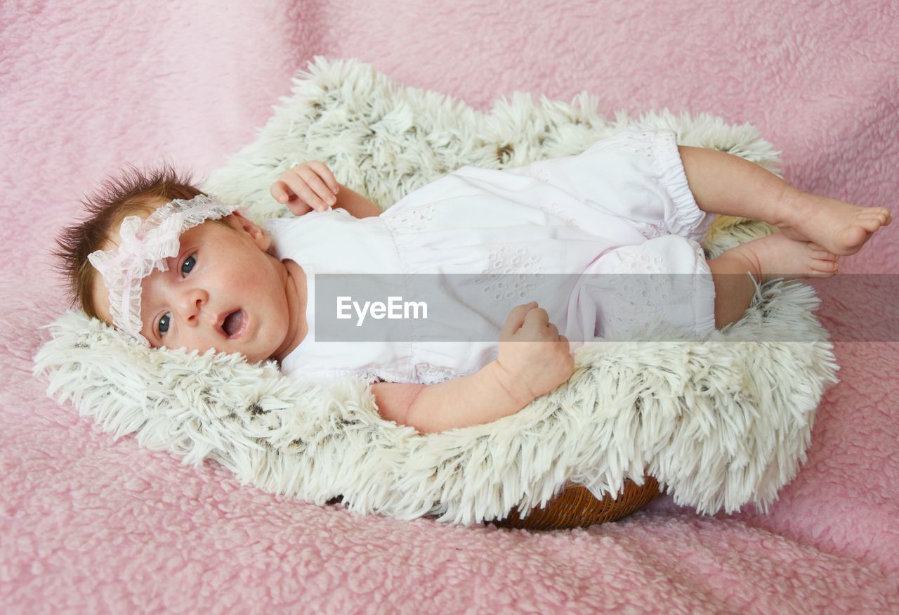 FULL LENGTH PORTRAIT OF CUTE BABY LYING ON BED