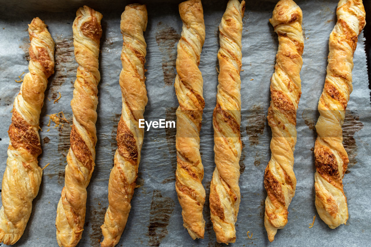 Freshly baked, crispy, puff pastry sticks on . perfect for a party.