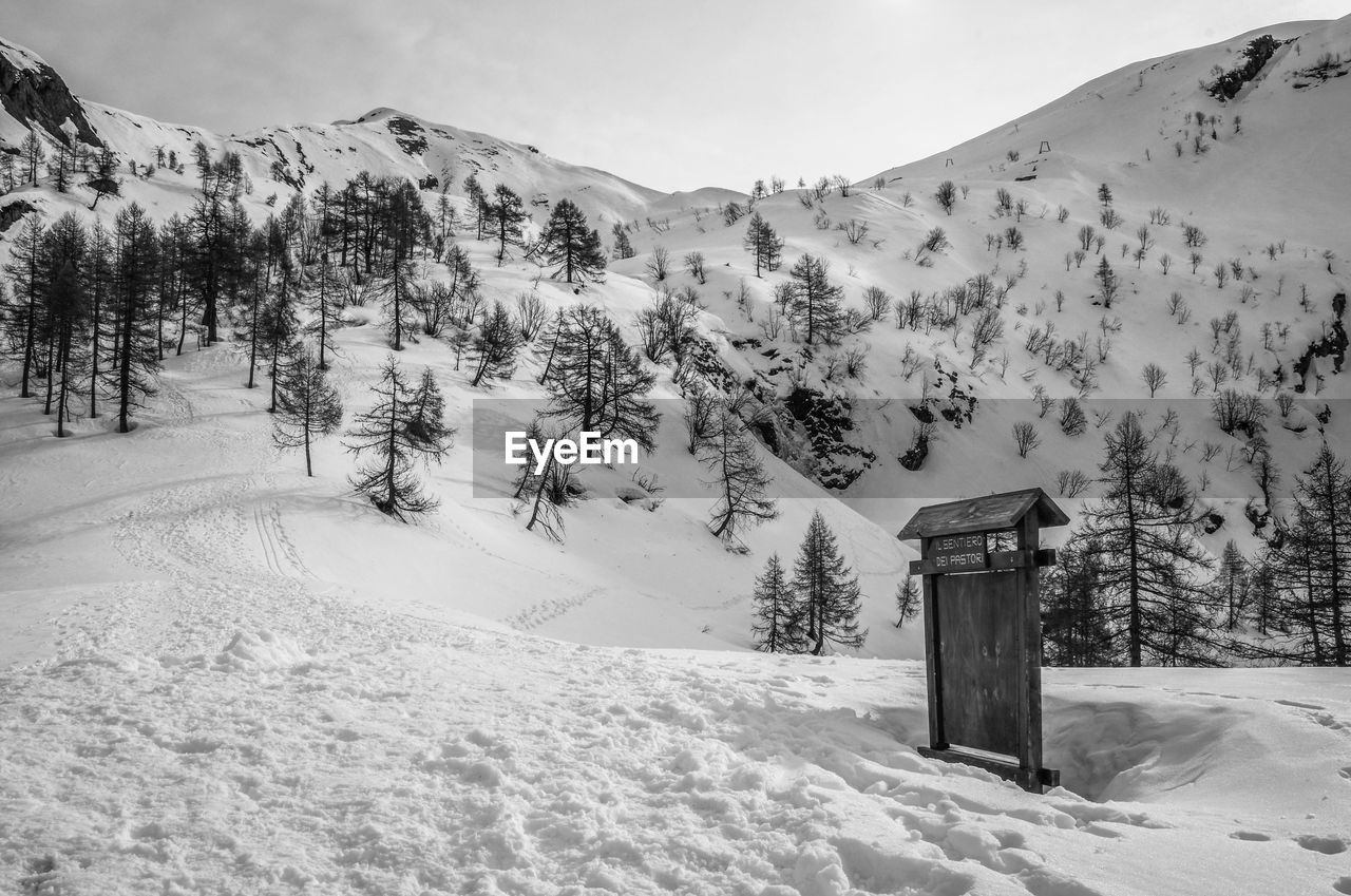 Scenic view of snow covered field against sky