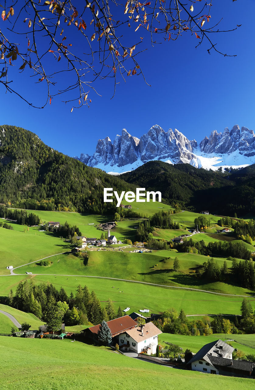 Scenic view of field and mountains against clear sky