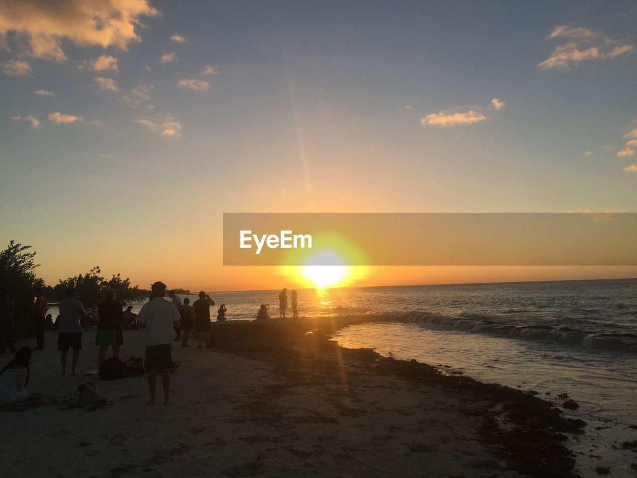 SCENIC VIEW OF BEACH AGAINST SKY AT SUNSET