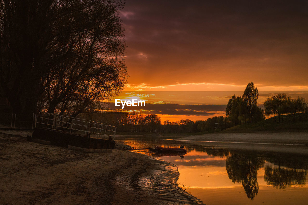 Scenic view of lake against cloudy sky