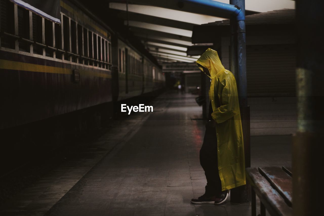 Side view of woman walking on railroad station platform