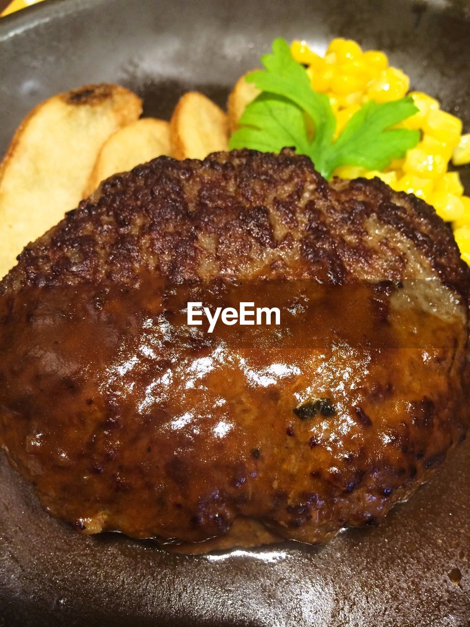 Close-up fried beef by corn served in plate