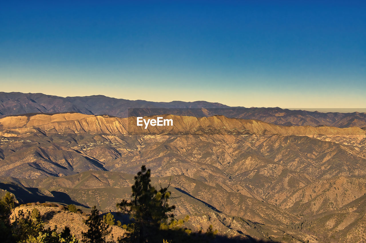 SCENIC VIEW OF DRAMATIC LANDSCAPE AGAINST BLUE SKY