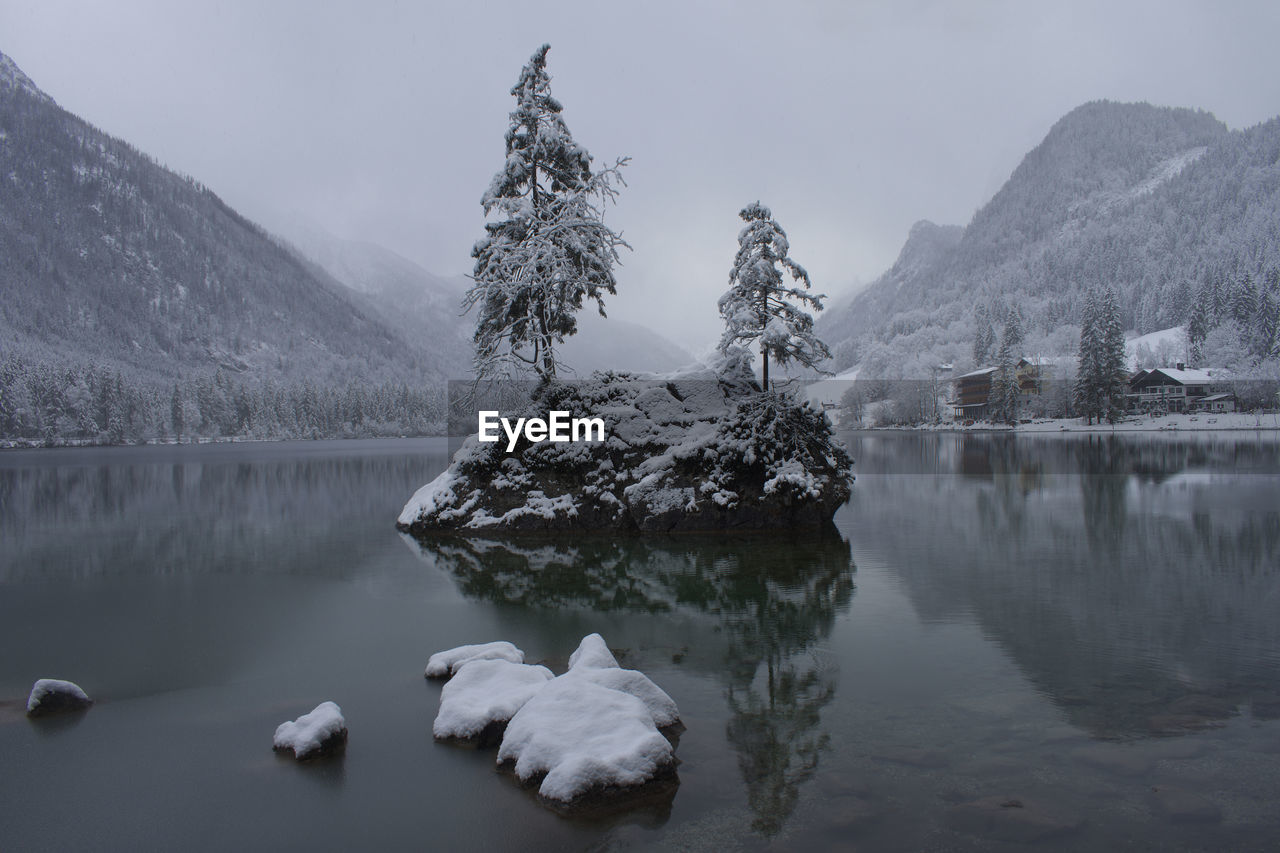 Scenic view of lake and snowcapped mountains against sky