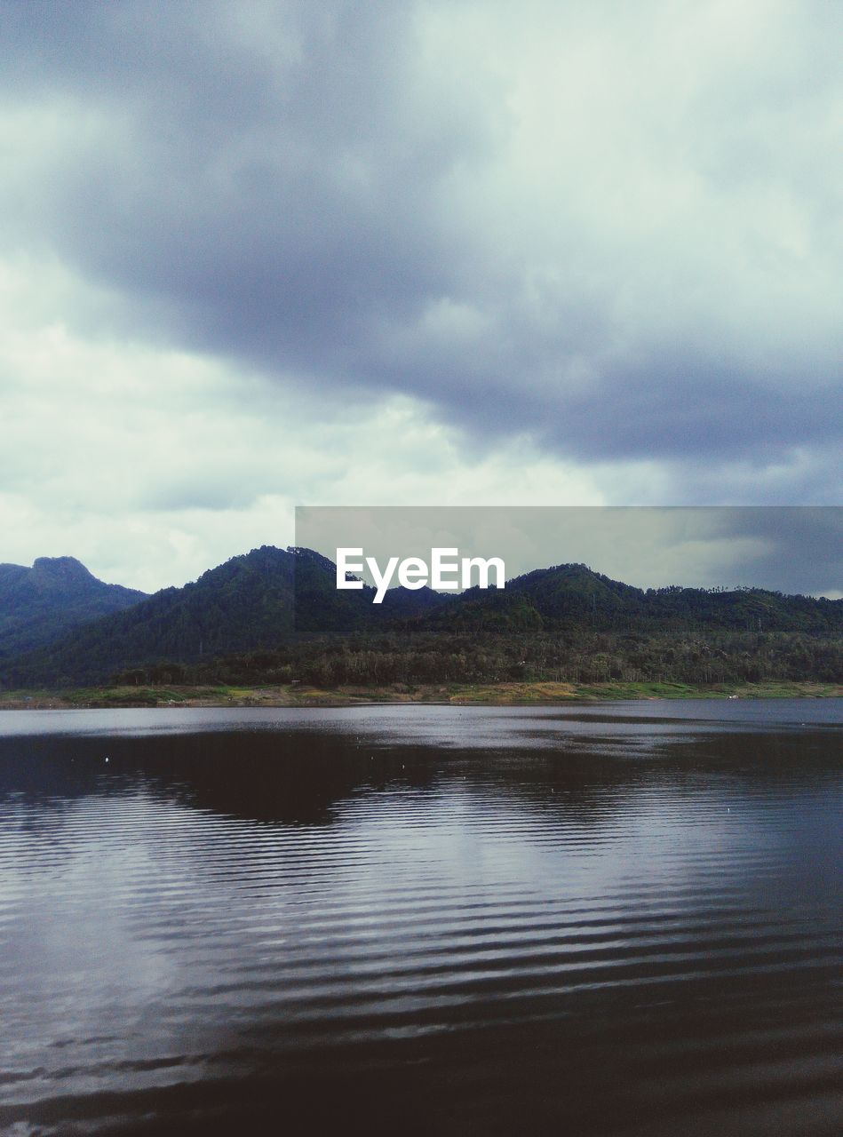 SCENIC VIEW OF LAKE BY MOUNTAIN AGAINST SKY