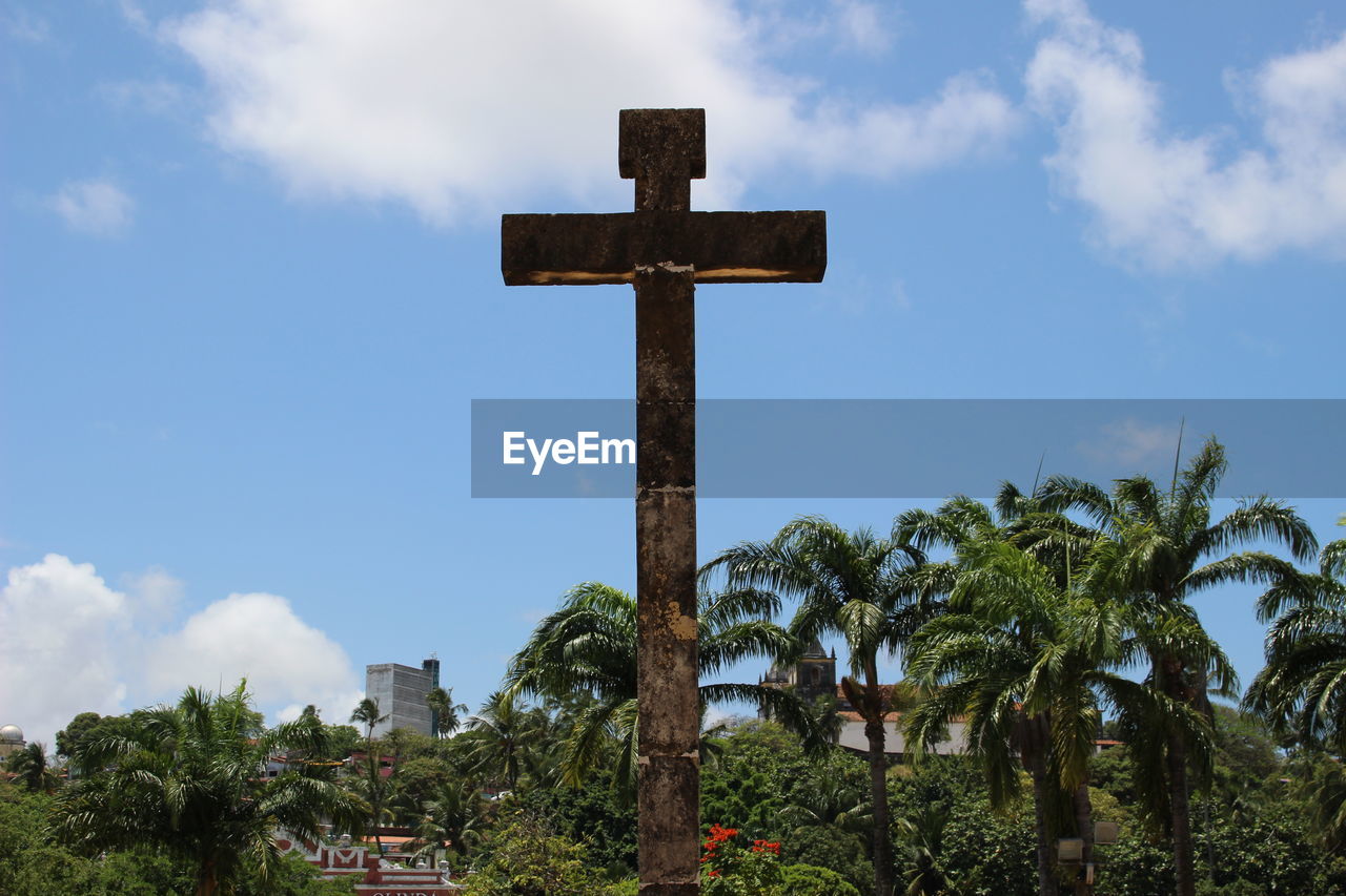 LOW ANGLE VIEW OF CROSS AND TREES AGAINST SKY