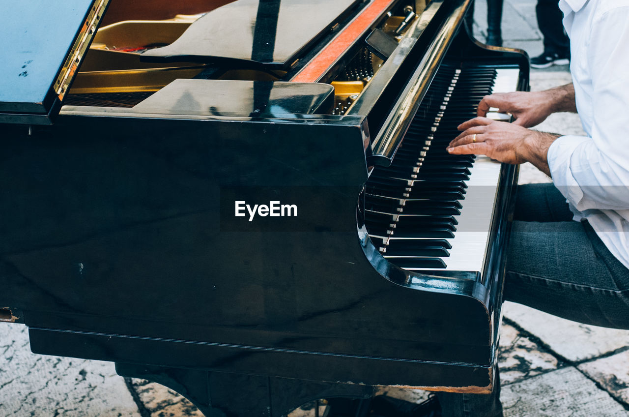 High angle view of man playing grand piano