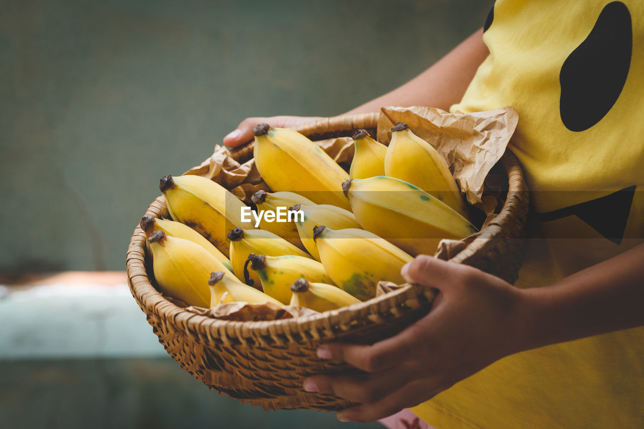 Close-up of hands holding a basket