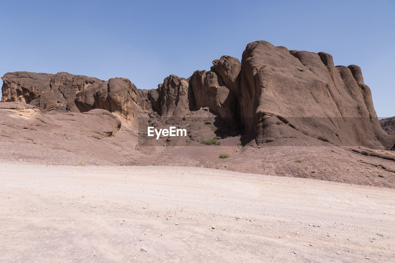 Rock formations in desert against clear sky