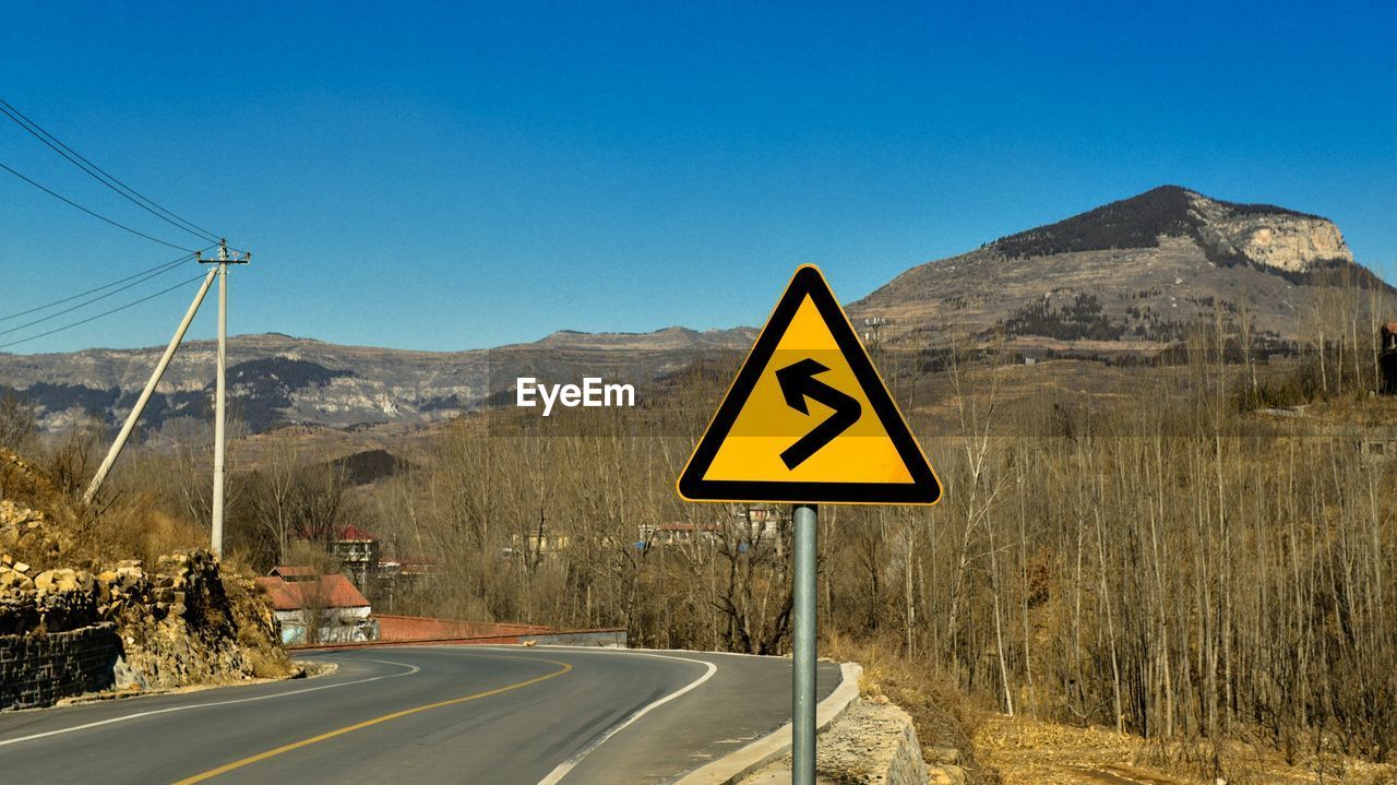 ROAD SIGN AGAINST CLEAR SKY