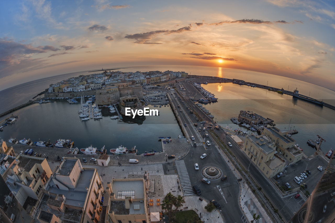 High angle view of buildings and city against sky during sunset