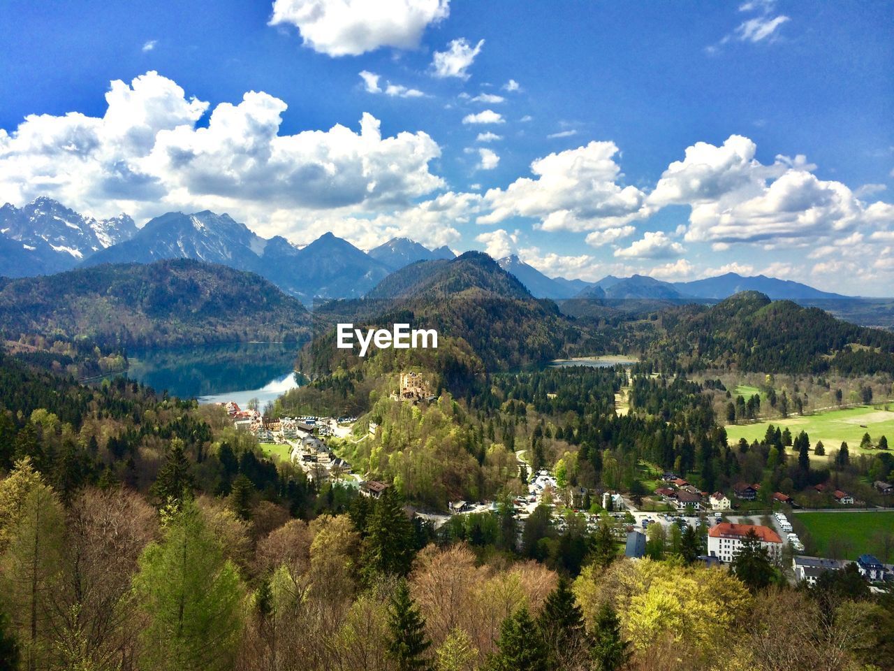 High angle view of fussen amidst tree mountains against cloudy sky