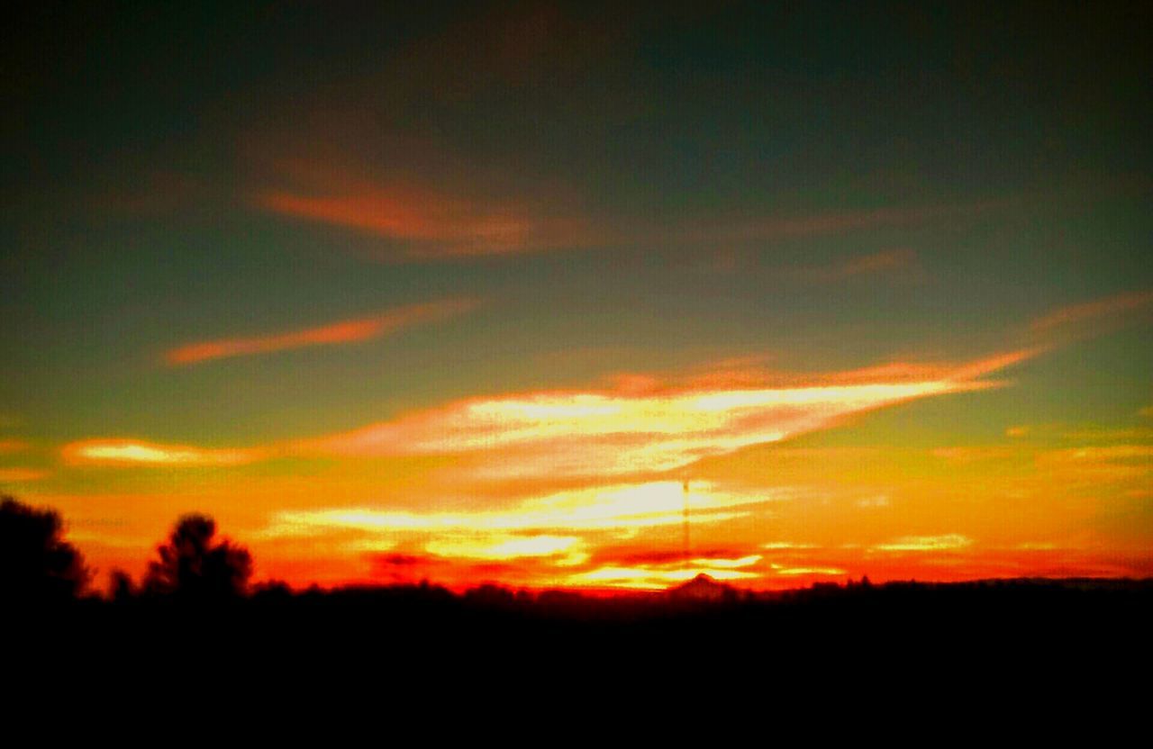 SILHOUETTE OF LANDSCAPE AGAINST DRAMATIC SKY