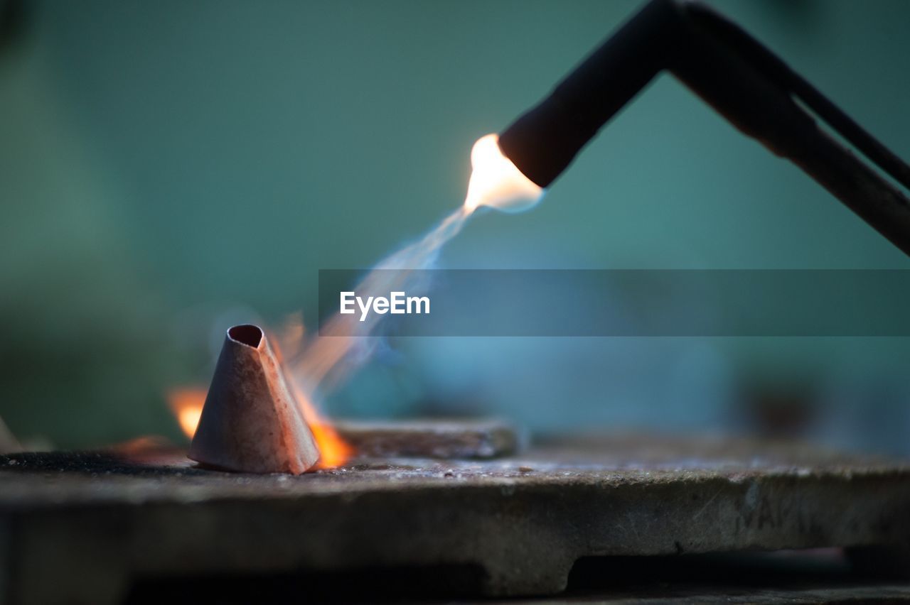 Close-up of burning metal with welding torch