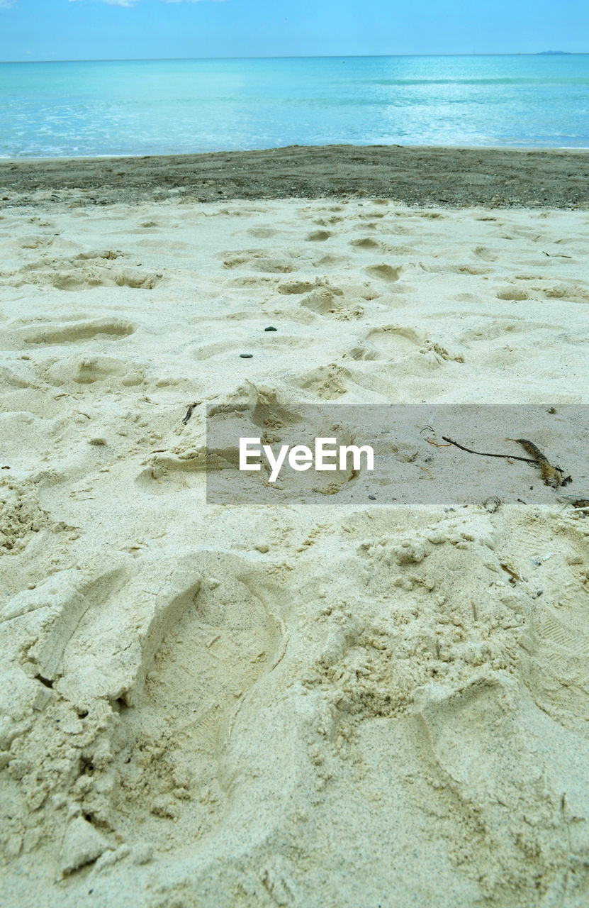 High angle view of sandy beach by sea