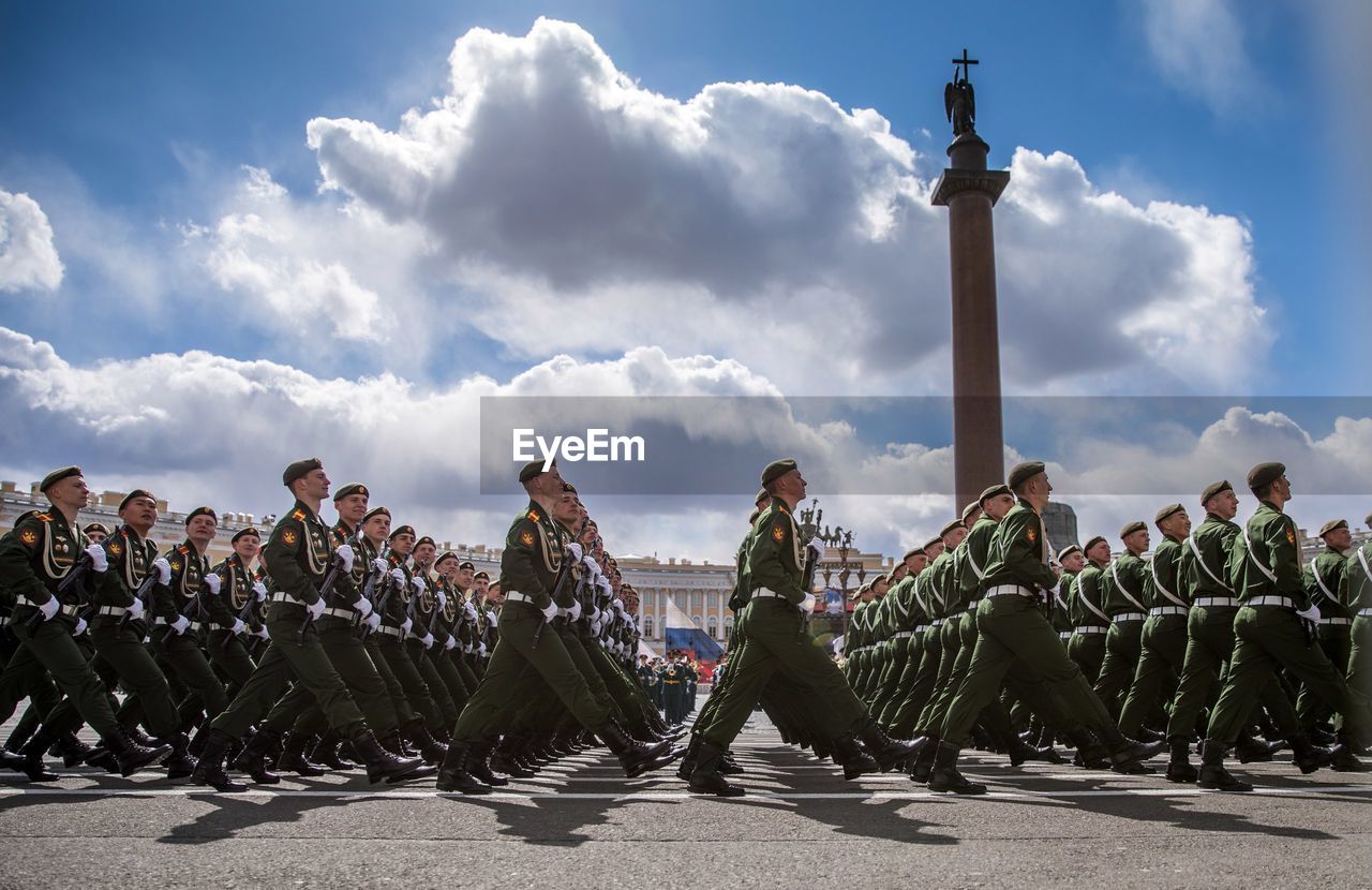 Side view of soldier marching at parade against sky during sunny day