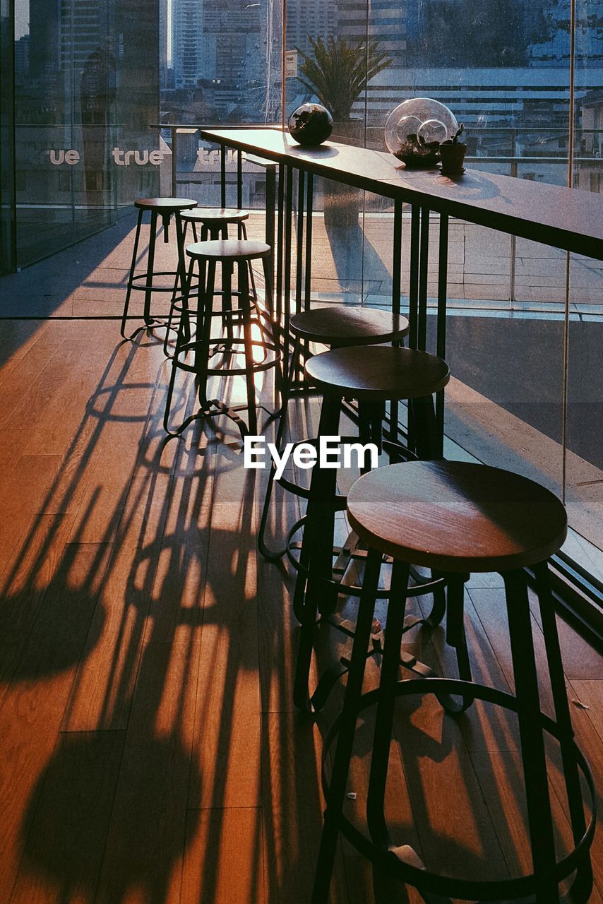 Empty stools by table in cafe
