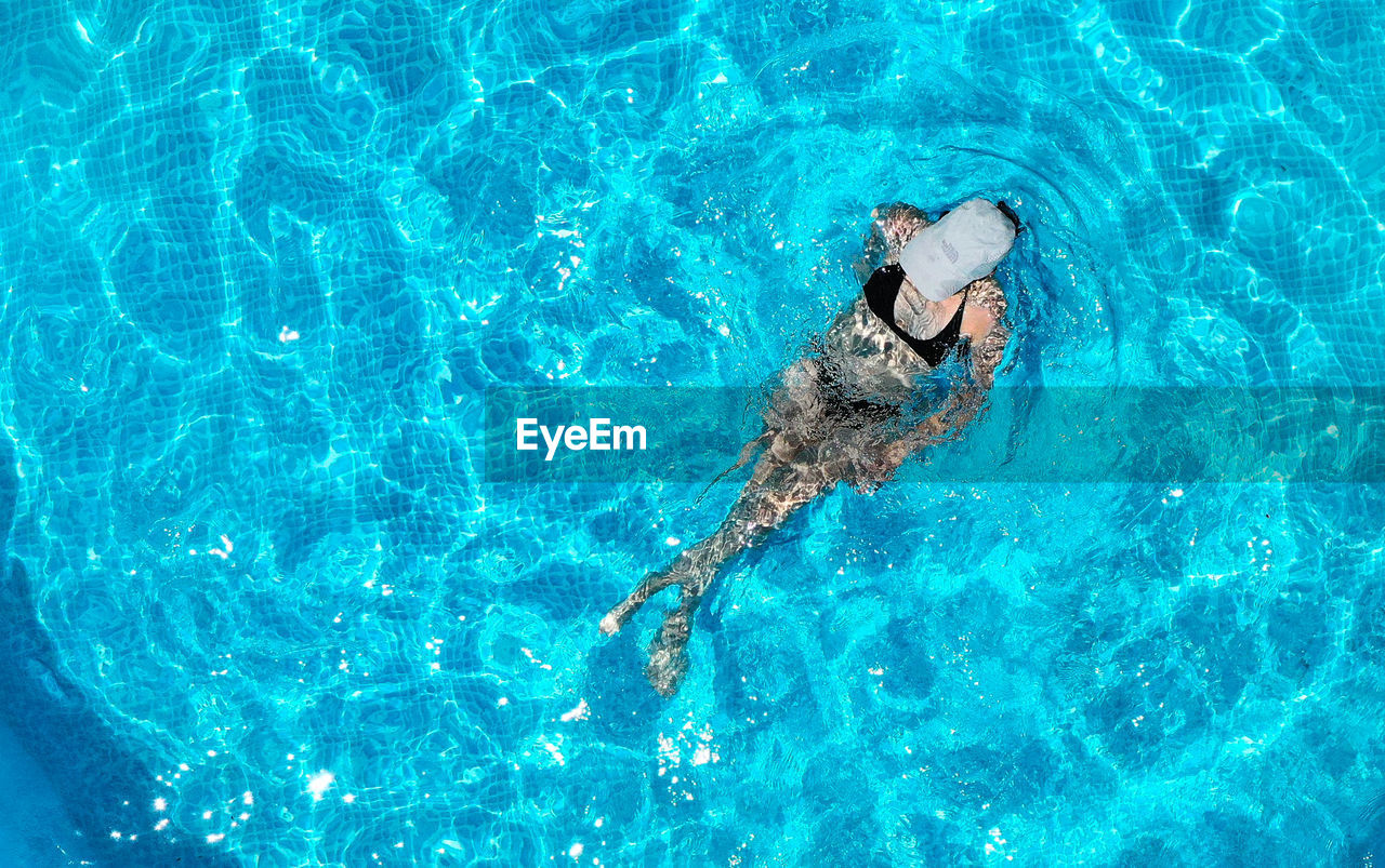 High angle view of man swimming in pool