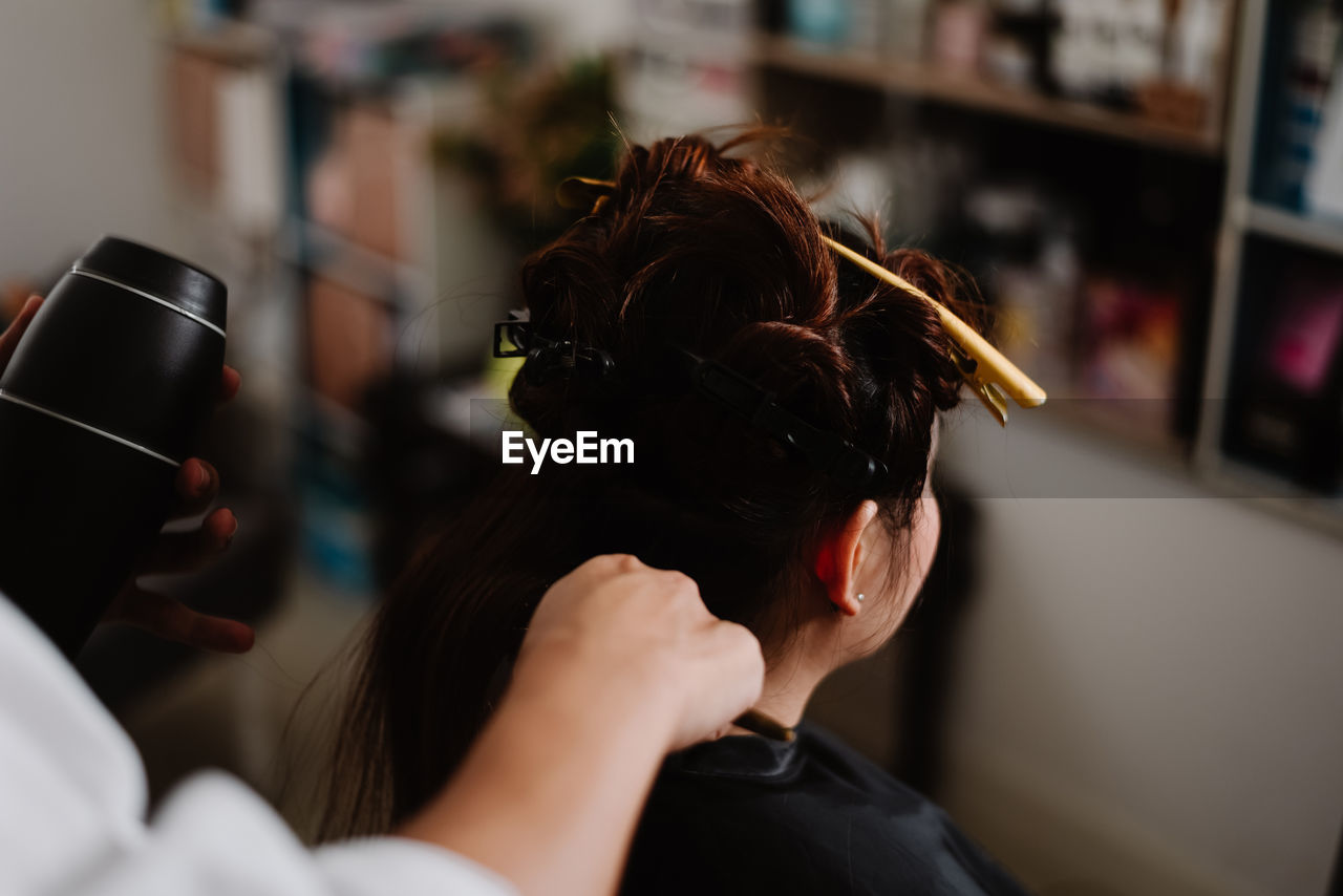 REAR VIEW OF WOMAN PHOTOGRAPHING THROUGH CAMERA