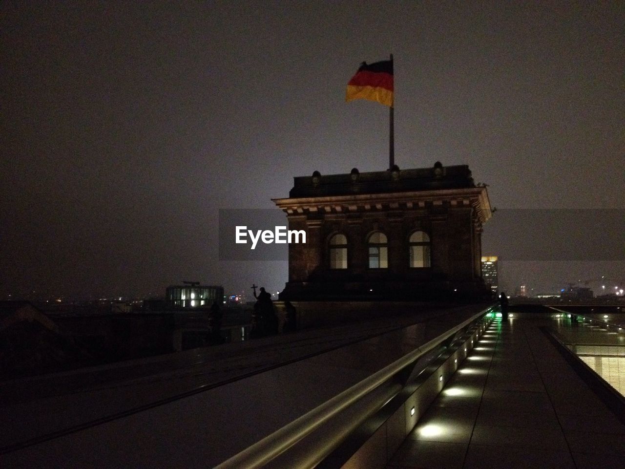 Flag waving on building at night