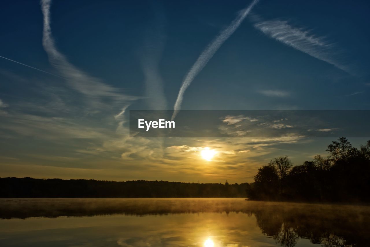 SCENIC VIEW OF LAKE AGAINST ORANGE SKY