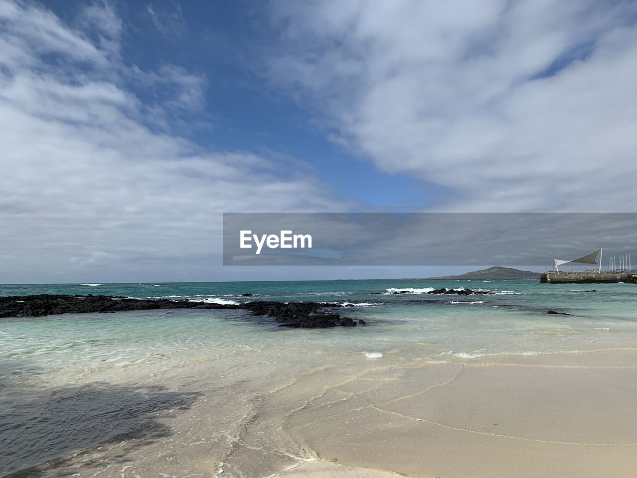 Scenic view of beach against sky on isabela island galapagos 