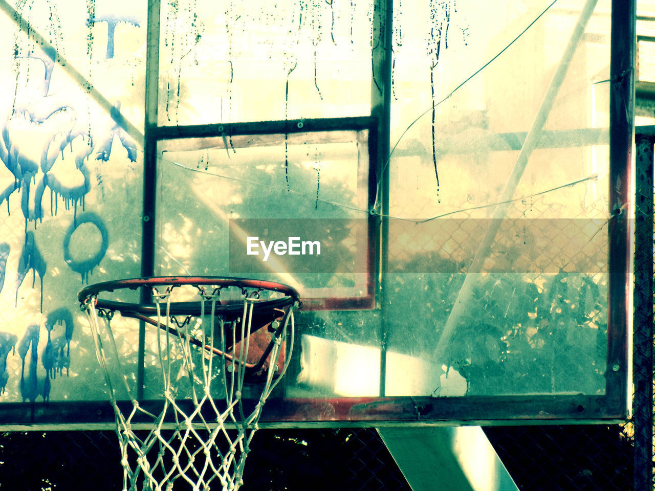 VIEW OF BASKETBALL HOOP SEEN THROUGH WINDOW