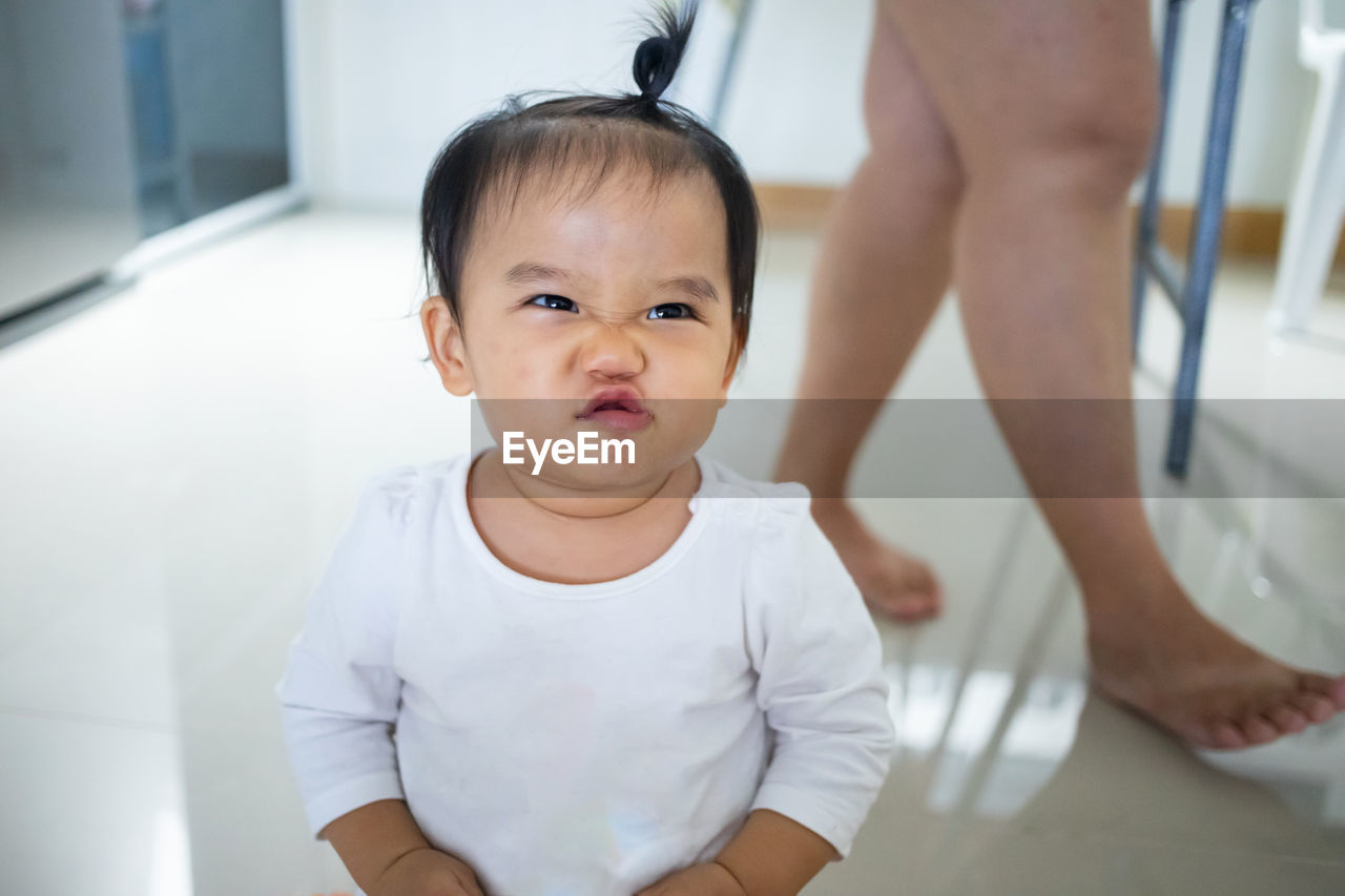 PORTRAIT OF CUTE BABY IN HOME