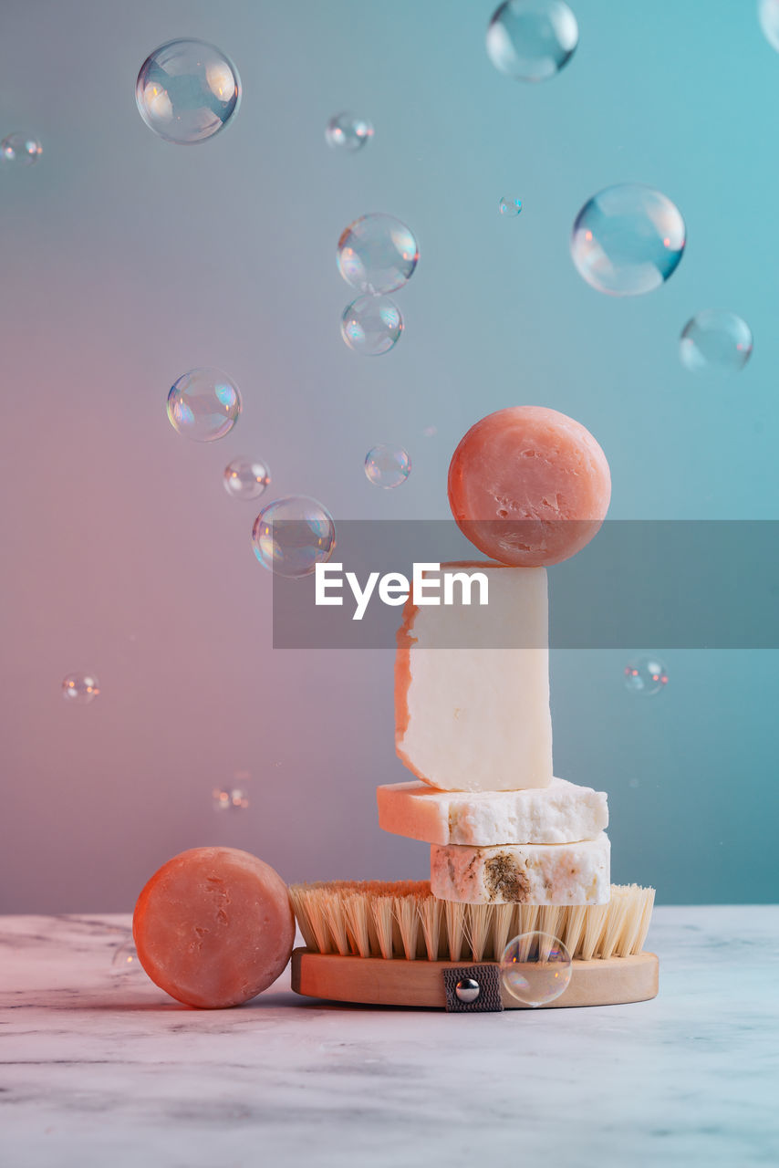 cropped hand of person holding ice cream on table