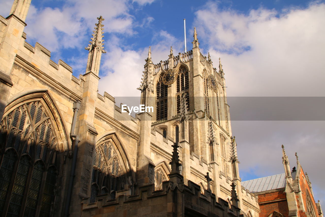 Low angle view of church against cloudy sky