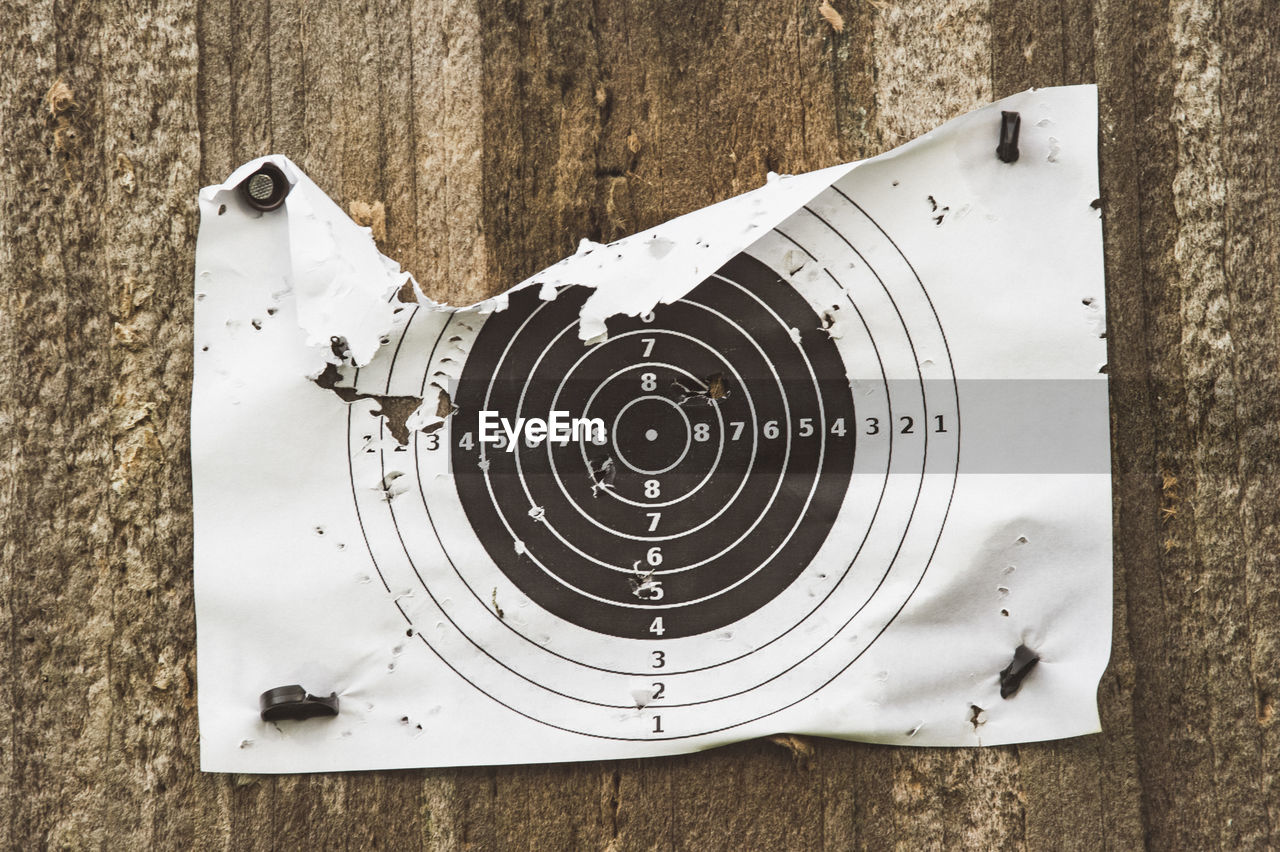 Close-up of bullet holes on paper target