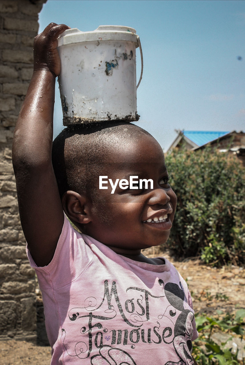 African child carrying a bucket