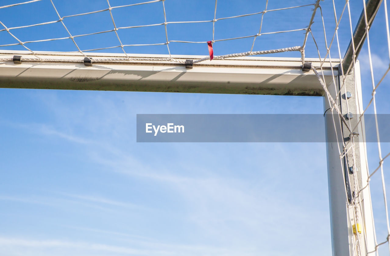 Low angle view of net against blue sky