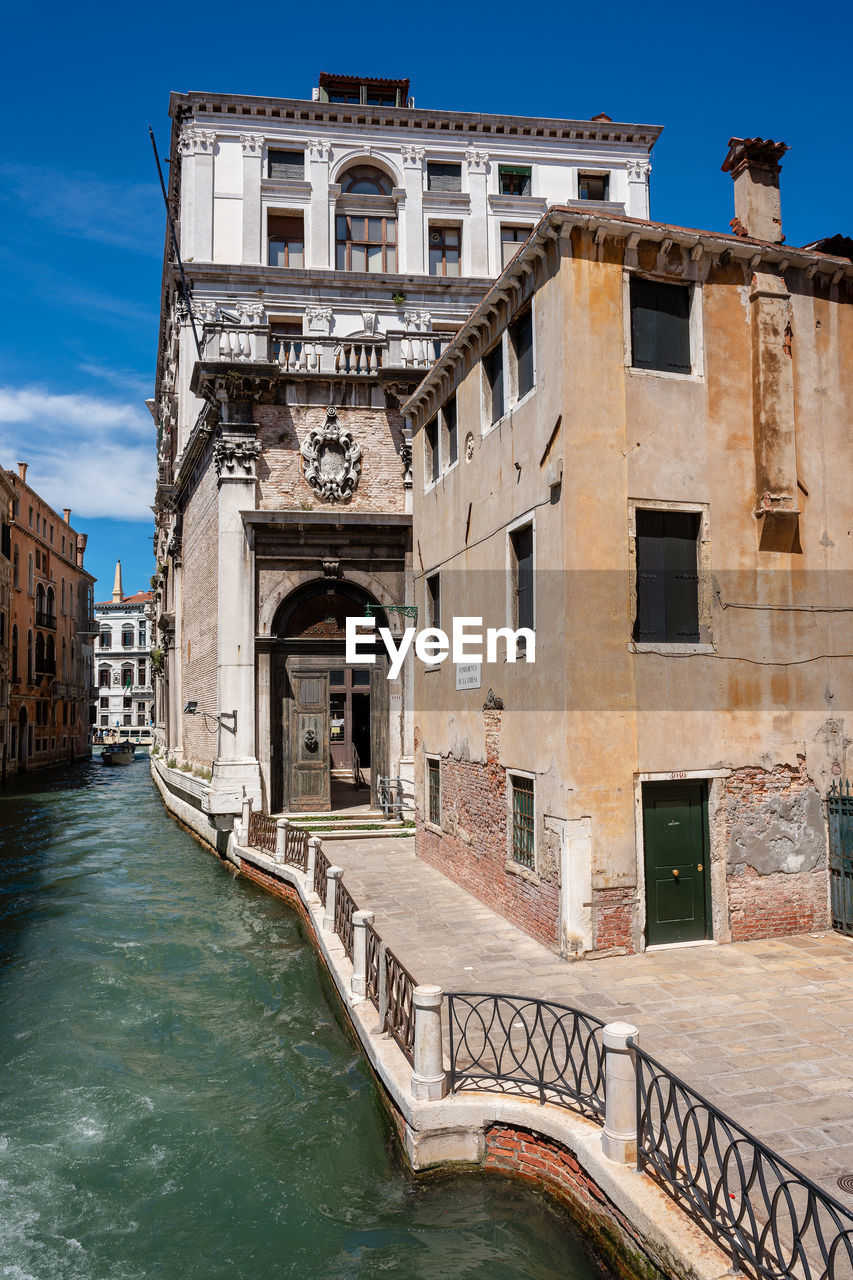 Canal amidst buildings in city