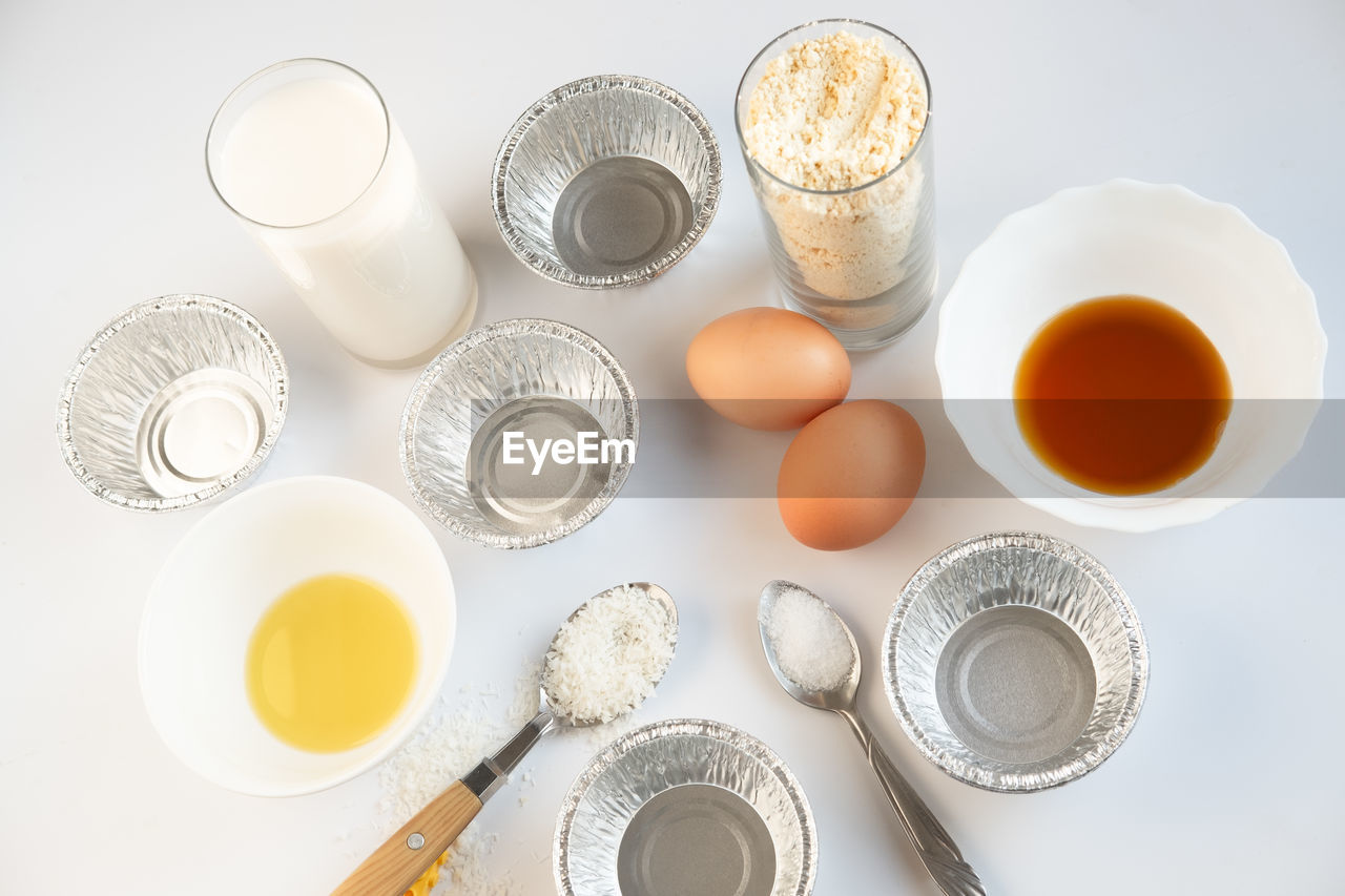 Ingredients for making cupcake on a white background. eggs, flour, yolk, salt and butter 