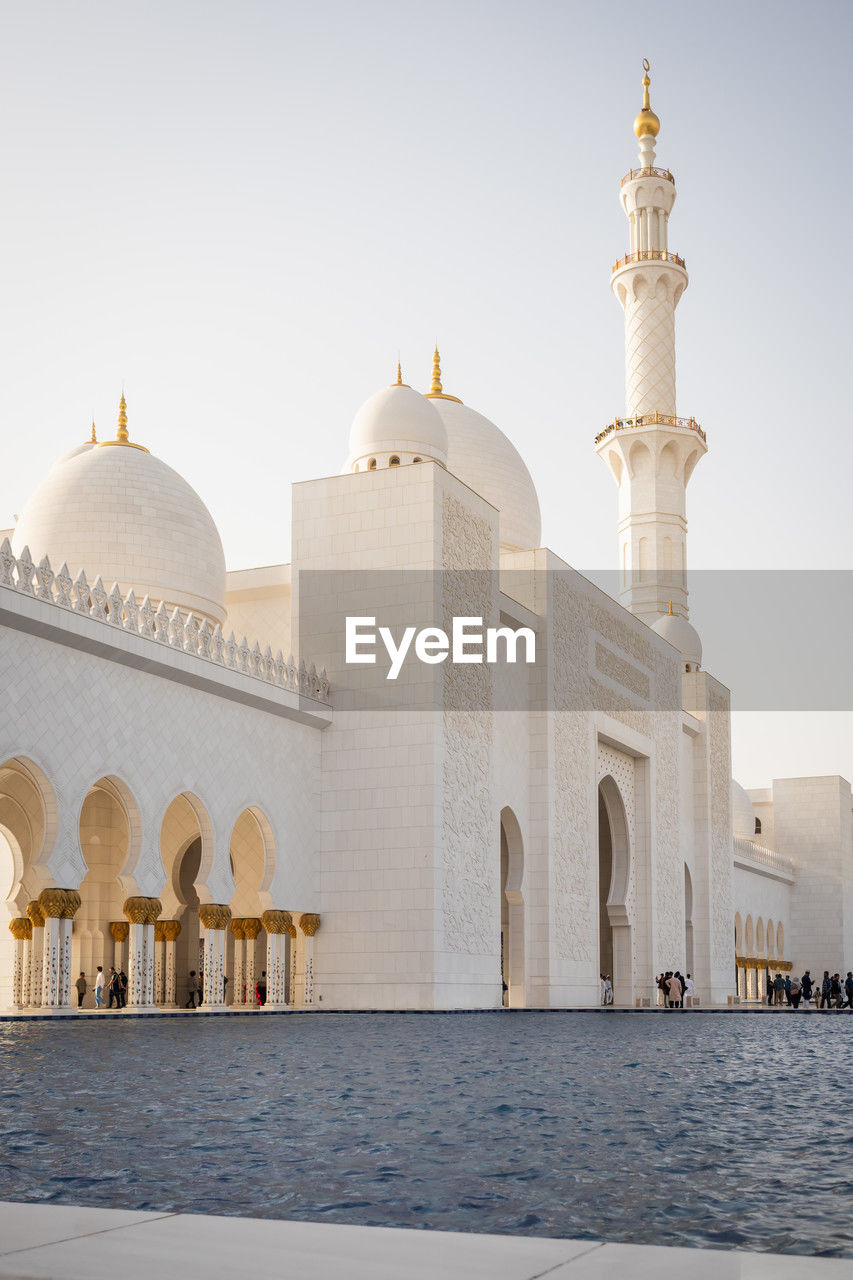place of worship, religion, architecture, travel destinations, dome, built structure, building exterior, travel, building, belief, caravanserai, arch, marble, tourism, water, spirituality, nature, landmark, calligraphy, history, sky, city, the past, historic site, outdoors