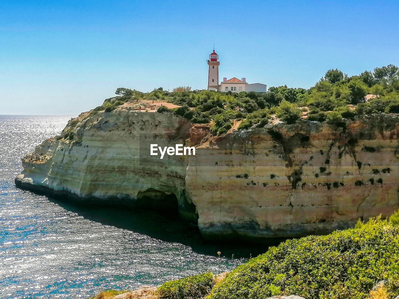 Scenic view of sea and lighthouse against sky