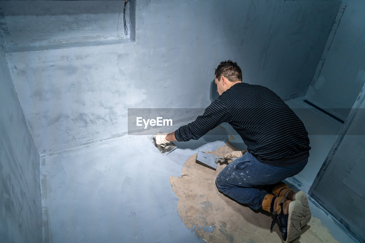 high angle view of man standing on floor