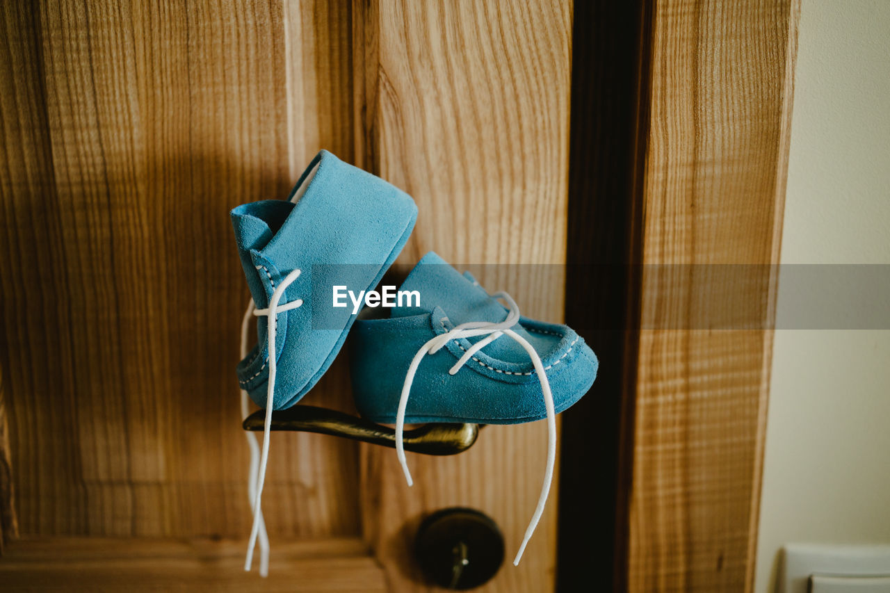 HIGH ANGLE VIEW OF SHOES ON WOODEN FLOOR