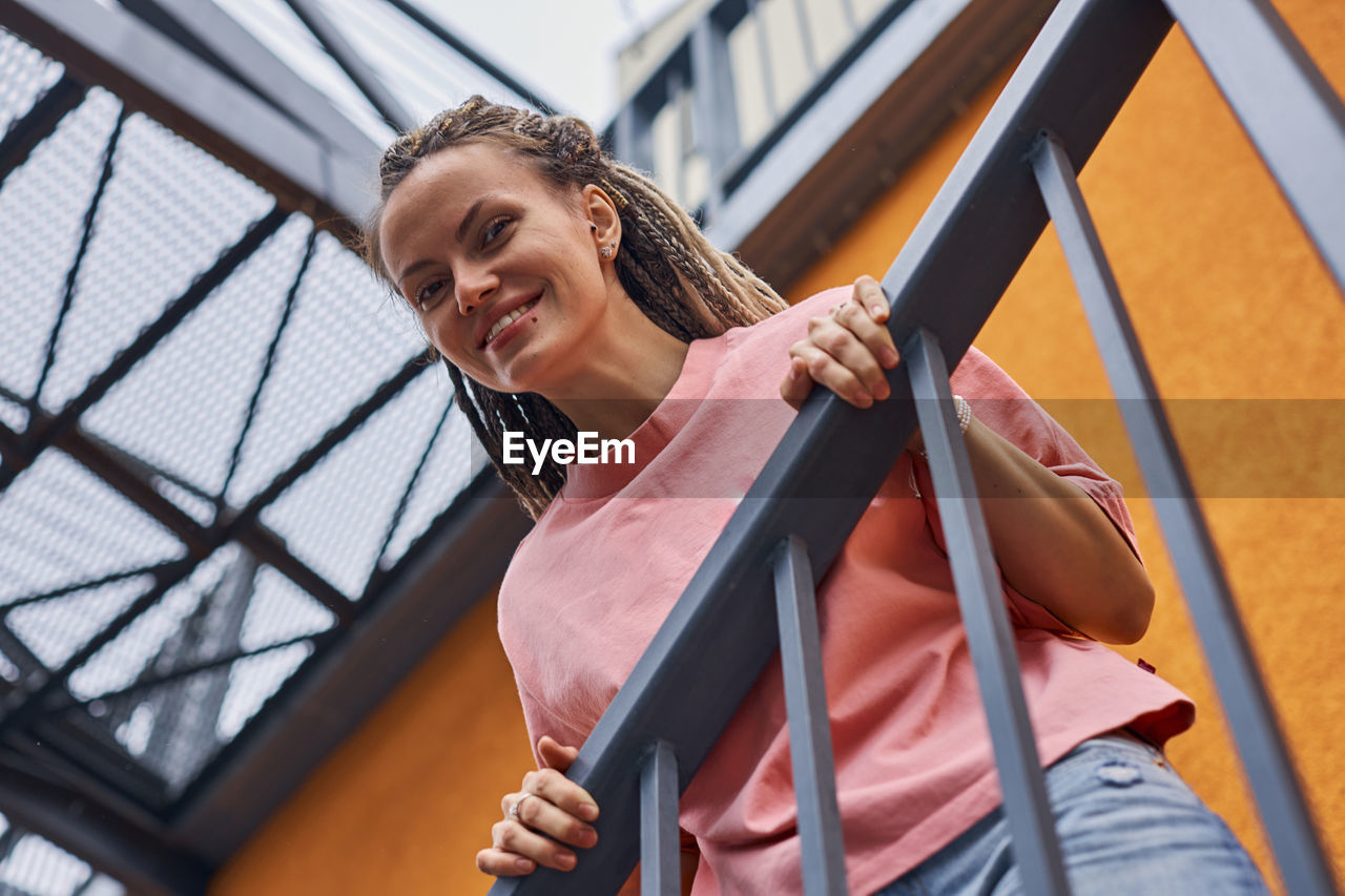 Portrait of smiling woman standing outdoors